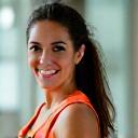 Portrait of Maria Rodriguez, an energetic and encouraging fitness professional.